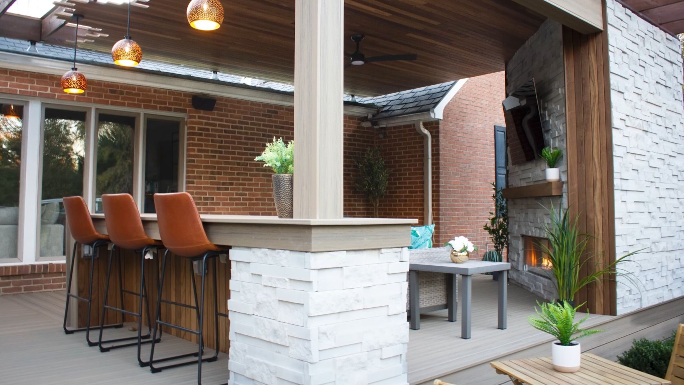 Modern outdoor kitchen with bar seating and covered patio deck in Tulare home